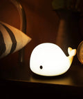 Cute Whale Night Light For Kids With 7 Color Changing LEDs, Tap Control Silicone Baby Night Lamp on bedside table