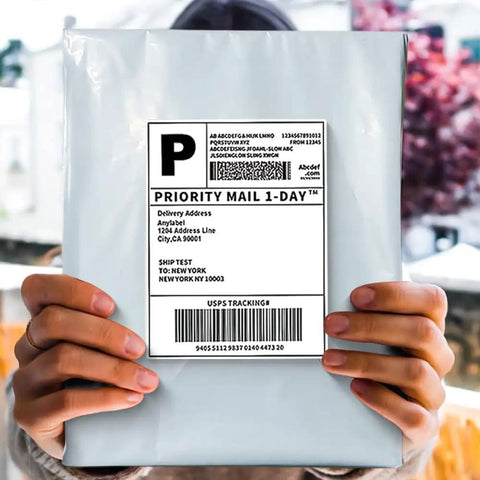 Person holding 500 Pack 10x13 Inch White Exterior Silver Interior Poly Mailers With Strong Self Sealing Adhesive Waterproof Tear Resistant Shipping Envelopes For Clothing Books And Accessories