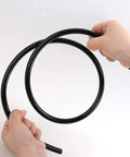 Hands holding black Heavy Duty Nylon Air Line 25ft One Quarter Inch OD Pneumatic Tube DOT Approved SAE J844