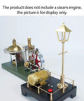 Build Your Own Badass Vertical Steam Engine Model Kit With A Transparent Cylinder Piston And Flywheel Power System Using Full Metal STEM Educational Parts And Rock Solid Spherical Boiler Design For Real Weekend Engineering Joy displayed with brass components and green base.