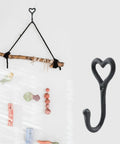 Dope Black Cast Iron Heart Shaped Wall Hooks For Home Decor Vibes And Closet Organization Heavy Duty Decorative Craft Hanging Hardware Reliable Set Of Two Pieces, one hook on a wall.