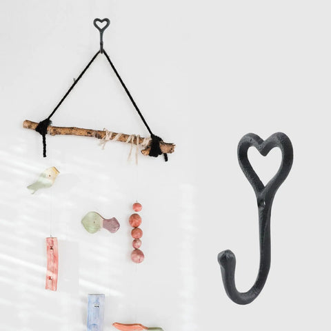 Dope Black Cast Iron Heart Shaped Wall Hooks For Home Decor Vibes And Closet Organization Heavy Duty Decorative Craft Hanging Hardware Reliable Set Of Two Pieces, one hook on a wall.