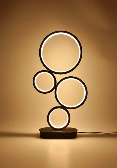 4 Circle Dimmable LED Table Lamp with Color Adjustable Light, Slick Modern Round Design, 12W, Black Finish, glowing on shelf