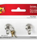 Quartz Key Rail For Damage Free Wall Organization No Drill Mount displayed in packaging with hooks visible.