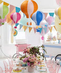 Hot Air Balloon Paper Lantern Decor Set Of 6 With Striped Blue Green Pink Orange Yellow Patterns 12 Inch Diameter And 16 Inch Expanded Height Perfect For Weddings Birthday Engagements Christmas Party Decor Party Ready Vibe hanging in decorated party room with table setting.