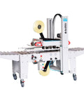 Heavy Duty Semi Automatic Case Sealer Machine For Random Corrugated Box Sizes With Universal Taping Heads on a conveyor.