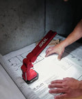 Heavy Duty Led Work Light 12 Volt Compact Task Lamp illuminating blueprints on a workspace with a rugged design.