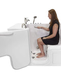 Woman sitting in a 30X52 wheelchair accessible transfer walk in tub featuring hydro microbubble soaking pool.