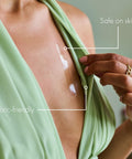 Double Sided Clothing Tape For All Day Hold Keeps Dresses Tops And Blouses In Place Clear Skin Safe Dress Tape For Clothes Transparent Body Tape Perfect For Wardrobe Malfunctions No Slip And Flawless Confidence All Day Secure being applied to green dress, highlighting skin-safe and fabric-friendly properties.