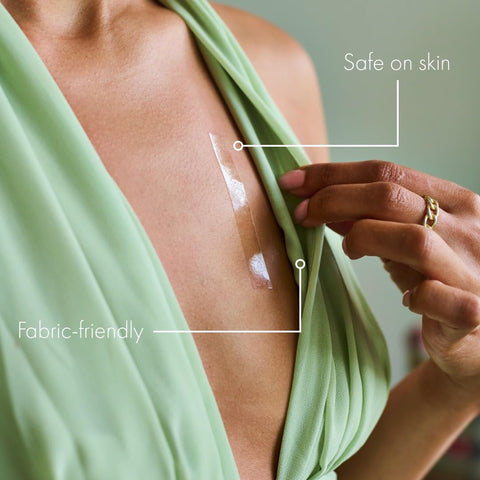 Double Sided Clothing Tape For All Day Hold Keeps Dresses Tops And Blouses In Place Clear Skin Safe Dress Tape For Clothes Transparent Body Tape Perfect For Wardrobe Malfunctions No Slip And Flawless Confidence All Day Secure being applied to green dress, highlighting skin-safe and fabric-friendly properties.