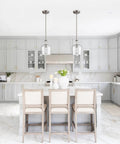 Modern Farmhouse Glass Pendant Light For Kitchen Island In Brushed Nickel Hand Blown Teardrop Shade 1 Light ETL Listed Wrought Iron Fixture Sloped Ceiling Adapter over a white kitchen island with gray cabinetry.