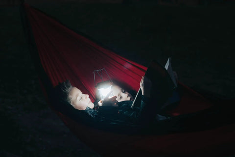 Children reading in hammock with 4 Pack Multicolor Camping Lanterns, Ultra Bright LED Tent Lights for Power Outages.