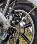 Close-up of Beefy Disc Brake Rotor For Bikes And Ebikes, 180mm with slotted heat dissipation design on electric motorcycle wheel.