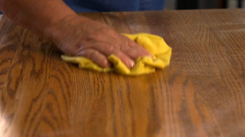 Game Changer Pre Treated Wood Furniture Dusting Cloths Pack Of Five Lint Free Wipes being used on wood surface.