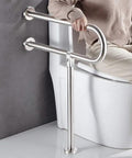 Sturdy 23.6 Inch Stainless Steel Handicap Toilet Grab Bar With T Shape Mount For Bathroom Safety Rails Wall And Floor Install No Slip Grip Ideal For Seniors And Elderly Bath Assistance Supports Up To Four Hundred Forty Pounds in use next to a toilet.