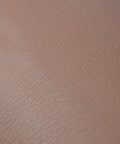 Close-up of brown self adhesive leather repair patch peel and stick for car seats armrests dashboards and home furniture easy DIY