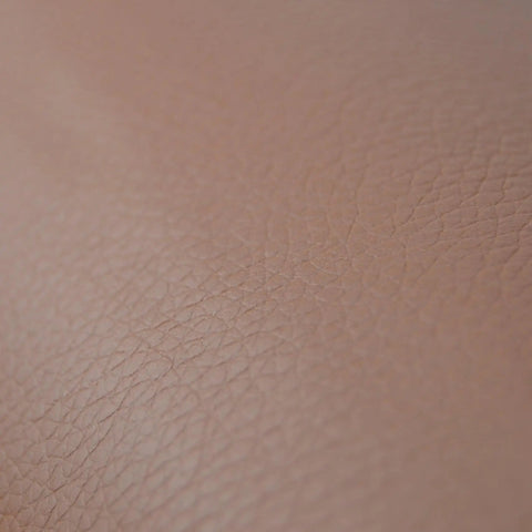 Close-up of brown self adhesive leather repair patch peel and stick for car seats armrests dashboards and home furniture easy DIY