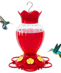 Outdoor 20 Oz Hummingbird Feeder With Ant Moat And Six Feeding Ports Perch Nectar Feeder For Garden Yard Deck Easy Hang No Fuss Attract More Hummingbirds With Bright Red Base And Realistic Flower Ports visible with red nectar and hummingbirds nearby.