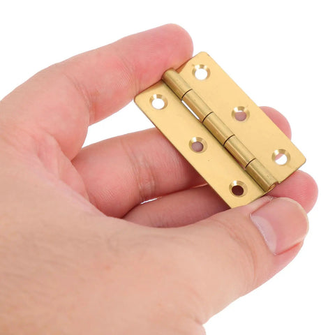 Golden Copper Piano Hinges Set, 4 Pcs for Jewelry Boxes And Wood Cabinets held in hand, showing smooth finish and hole detail.