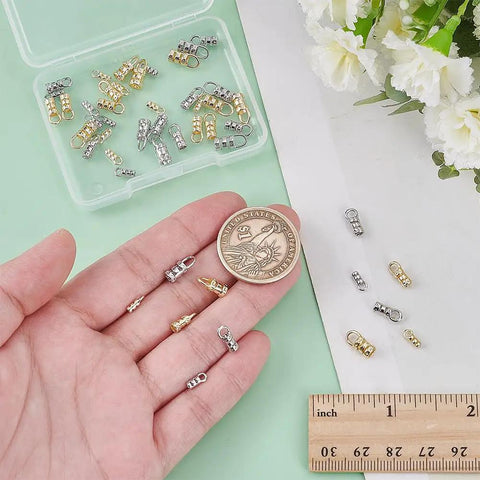 Must Have Cord End Caps Set For Jewelry Making 48 Pieces Brass End Caps With Loops next to a ruler and coin for scale.
