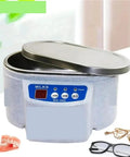 Ultra Portable Ultrasonic Cleaner For Jewels, Glasses, Rings, And Watches in compact design with opened lid and jewelry nearby.