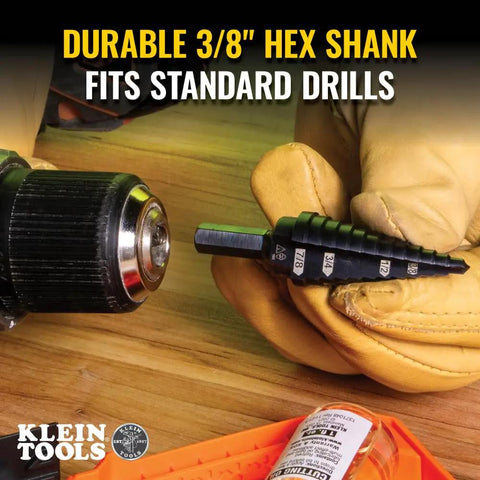 Close-up of Step Drill Bit 14 Double Fluted 3/16 to 7/8 Inch with Easy Read Step Markings next to a drill, with 3/8 Inch Hex Shank.