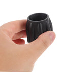 Hand holding Scuba Tank Valve Replacement Part For Tight Seal And Top Notch Safety, compact cylinder valve accessory in black.