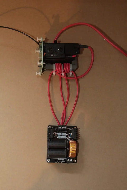Mini DC Induction Jacobs Ladder High Voltage Arc Tesla Coil Kit with ZVS power supply and wires on a neutral background.