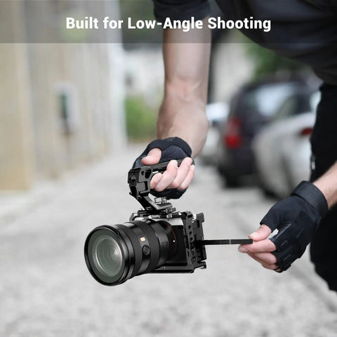 Person using Lightweight NATO Top Handle For DSLR Camera Cages With Quick Release Universal Top Grip for low-angle shot