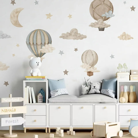 Watercolor Hot Air Balloon Fabric Wall Sticker Peel and Stick Decals With Stars and Clouds for Baby Nursery Kids Bedroom Playroom Decor 120 x 40 cm Eco Friendly Non Toxic Pre Cut Totally Kid Friendly applied on a nursery wall.