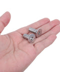 Close-up of 10 Piece Stainless Steel M8x60mm Full Thread Flat Head Screws With Hex Socket, Countersunk Machine Fasteners in hand.