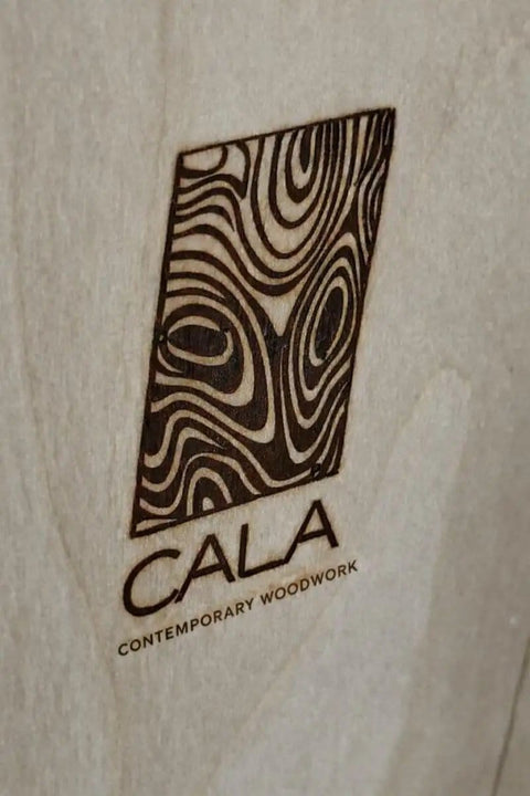 CALA Contemporary Woodwork logo etched on handcrafted live edge spalted Hackberry barn door from Minnesota.