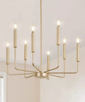 Totally Chic Modern Farmhouse Gold 8 Light Chandelier For Dining Room And Living Spaces hanging in a bright interior.