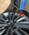 Red 5 Piece Tire Changer Rim Protectors Premium Soft Polyurethane Wheel Savers on a shiny silver wheel during tire change.