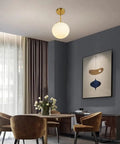 Dining room with Dope Globe Pendant Light With Matte White Glass And Brass Finish One Light Mid Century Modern Ceiling Fixture