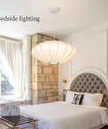 Bedroom with Italian Silkworm Cocoon Pendant Light With White Faux Silk Drum Shade hanging above a bed, showcasing minimalist style.