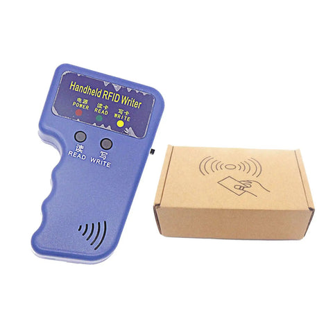 Handheld 125KHz RFID Copier And Duplicator For T5577 And EM4305 Cards, purple device next to brown box, angled view
