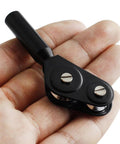 Close-up of black metal fishing rod tip roller with two silver screws