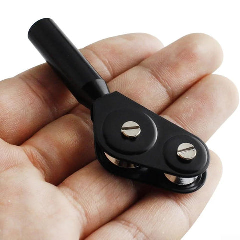 Close-up of black metal fishing rod tip roller with two silver screws