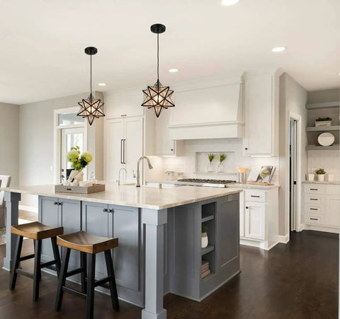 Seeded Glass Moravian Star Pendant Light With Black Industrial Finish in a modern kitchen, above a white island countertop.