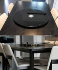 Heavy Duty Black Tempered Glass Lazy Susan Serving Turntable Featuring Smooth As Butter Spin For Effortless Food Sharing And Serious Kitchen Game Changer Vibes In A Generous 31 Inch Format on a dining table with white chairs.
