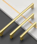 Top Notch Brushed Gold Cabinet Pulls 10 Pack 5 Inch Drawer Handles For Kitchen Cabinets on a counter surface.