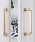 10 Pack 5 Inch Center To Center Brushed Brass Kitchen Cabinet Pulls Zinc Alloy Solid Round Cabinet Handles installed on white doors