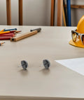 Two No Slip Felt Pads For Furniture Feet And Chair Legs on desk with pencils and hard hat