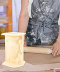 Woman working next to a Roman Column Balustrade Concrete Mold For Easy DIY Baluster Casting 8.26 By 5.90 By 5.51 Inch Plastic Mold