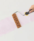 Pineapple Texture Sponge Paint Roller for Walls creating a pink pattern on the wall with a textured foam roller for DIY decor.