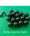 Twenty Piece Lot Of 1.588Mm Silicon Nitride Ceramic Balls G5 Grade arranged on a green surface, showcasing their precision and glossy finish.