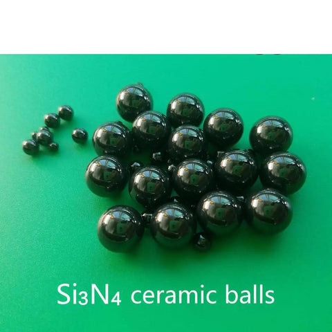 Twenty Piece Lot Of 1.588Mm Silicon Nitride Ceramic Balls G5 Grade arranged on a green surface, showcasing their precision and glossy finish.