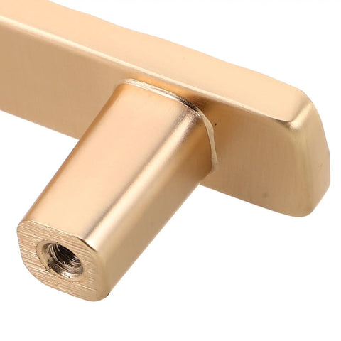 Close-up of a gold zinc alloy cabinet pull handle, showcasing the screw hole detail of the Two Pack Zinc Alloy Cabinet Pull Handles With Screws For Kitchen Cabinets Wardrobe And Dresser Doors Modern Metal Drawer Pulls Hardware Accessories Dope Quality Ready To Install Built To Last.