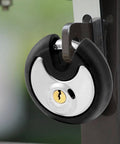Outdoor Stainless Steel Disc Padlock With Waterproof Shield And Rubber Bumper installed on gate for security